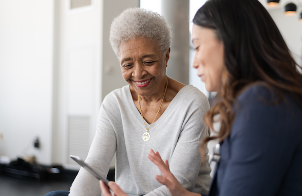 Clinician explaining medication profile to an elderly patient in a professional setting